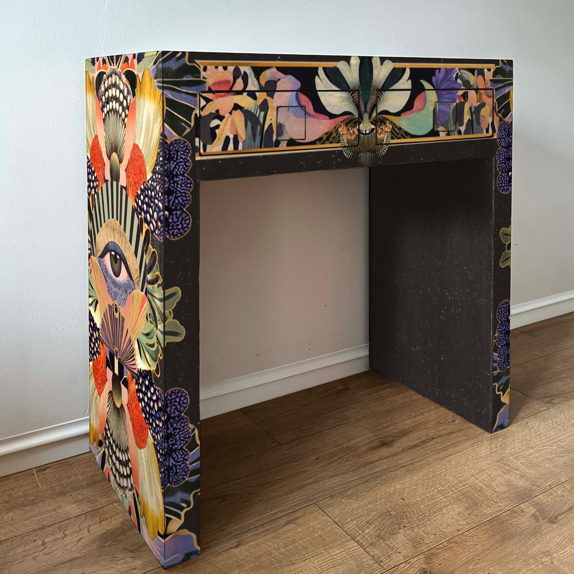 Art deco style decorated modern dressing table with colourful sides and front and dark iner surfaces.