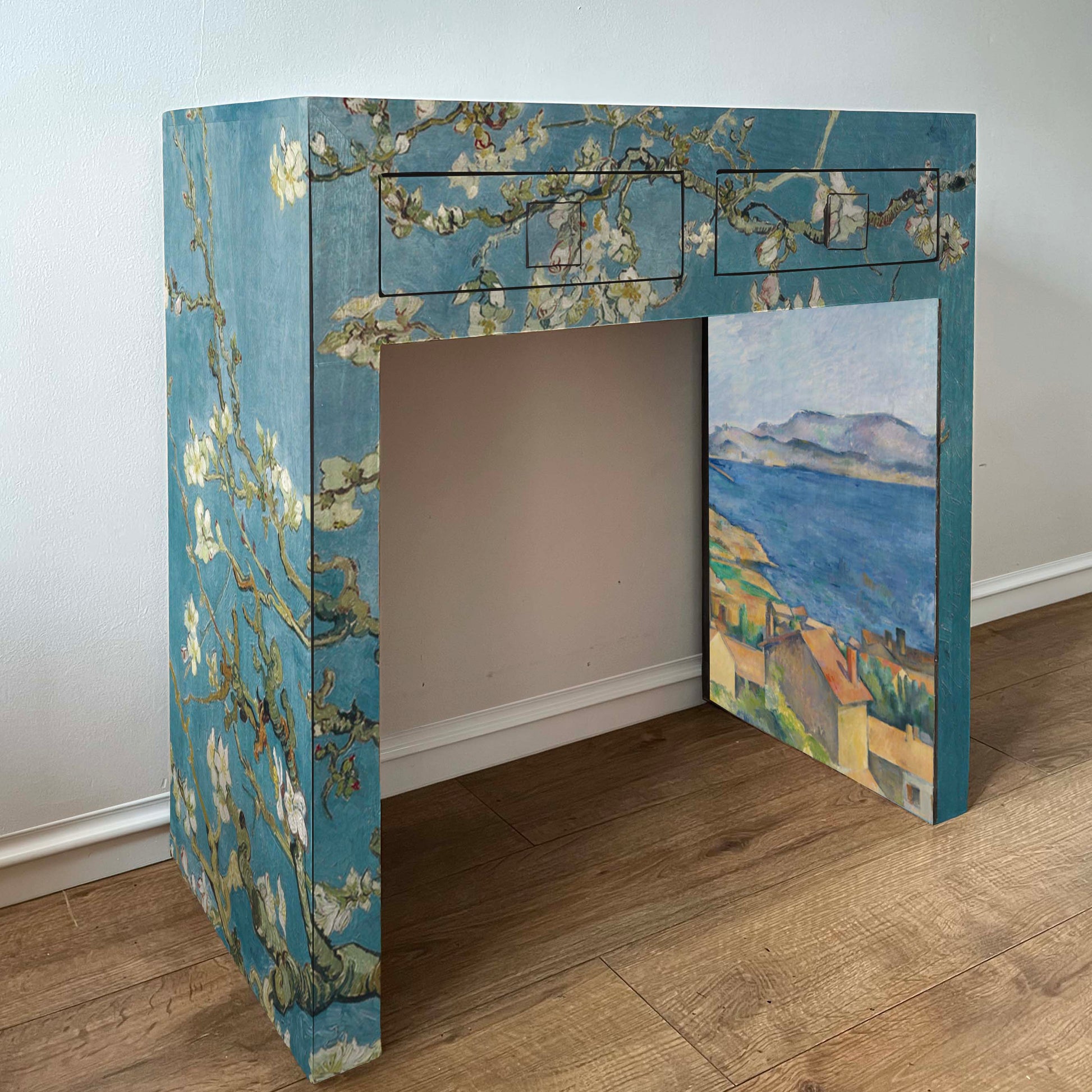 Desk with Van Gogh 'Almond Blossoms' and designs on a plain background