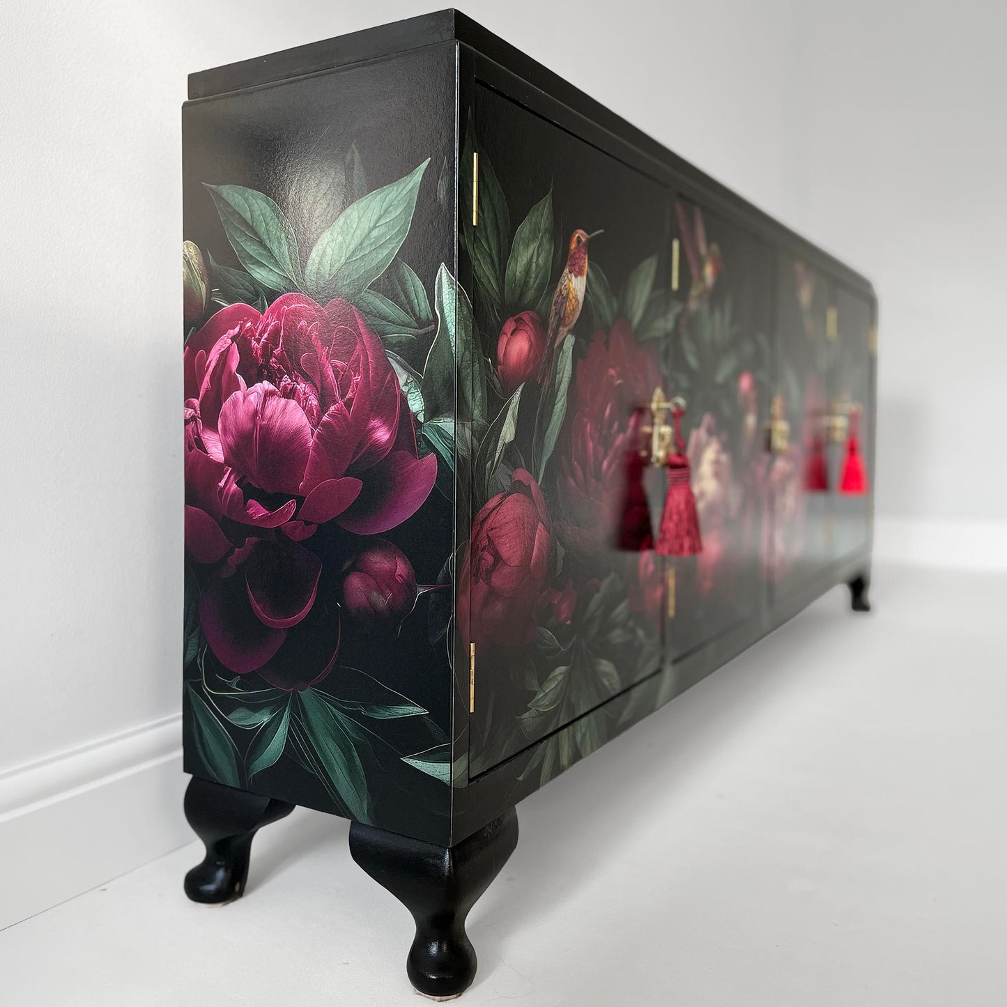 Slim black sideboard with cupboards decorated with pink peonies