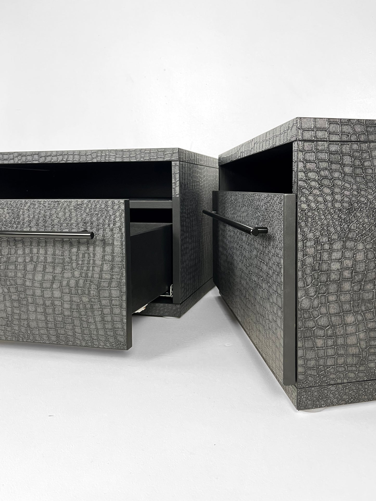 Upcycled Ikea bedside cabinets painted black with textured snakeskin pattern